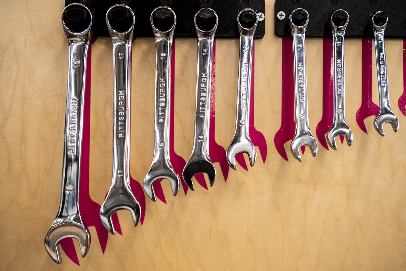 Wrenches hanging from a rack in the Makerspace in EXP.