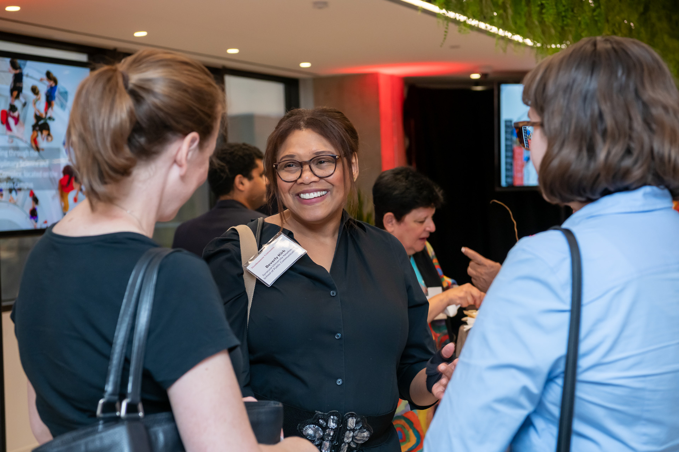 Audience members chatting with each other at the Experience Powered by Northeastern campaign stop in Arlington.