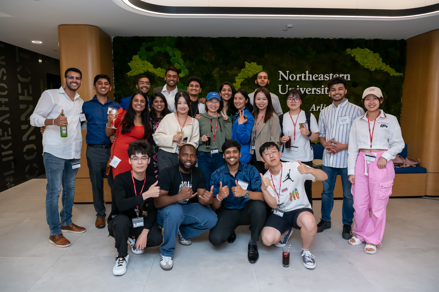 People posing for a group photo at the Experience Powered by Northeastern campaign stop in Arlington.