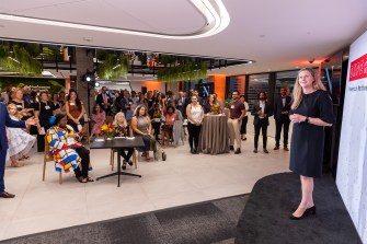 Jamie Jones Miller speaking to a crowd at the Experience Powered by Northeastern campaign stop in Arlington.