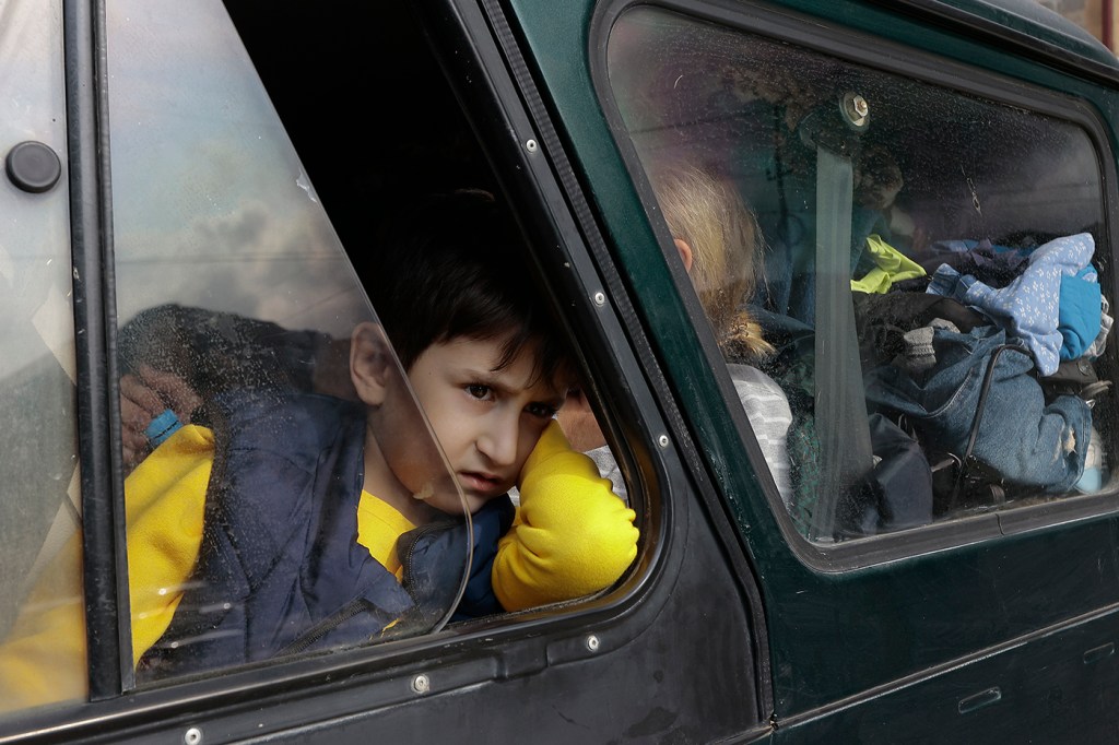 Ethnic Armenian boy looks out the window of a car.