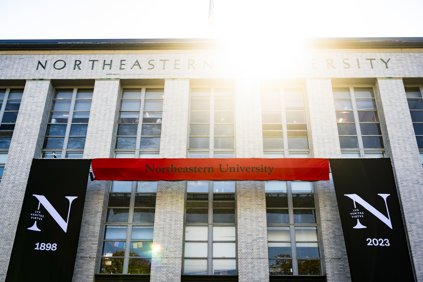 Ell Hall with a Northeastern banner rolled up in front of it.