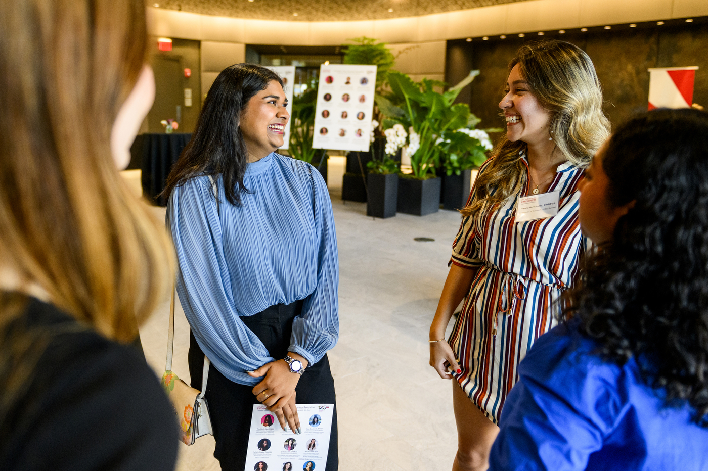 Aditi Bansal smiling and talking with another participant