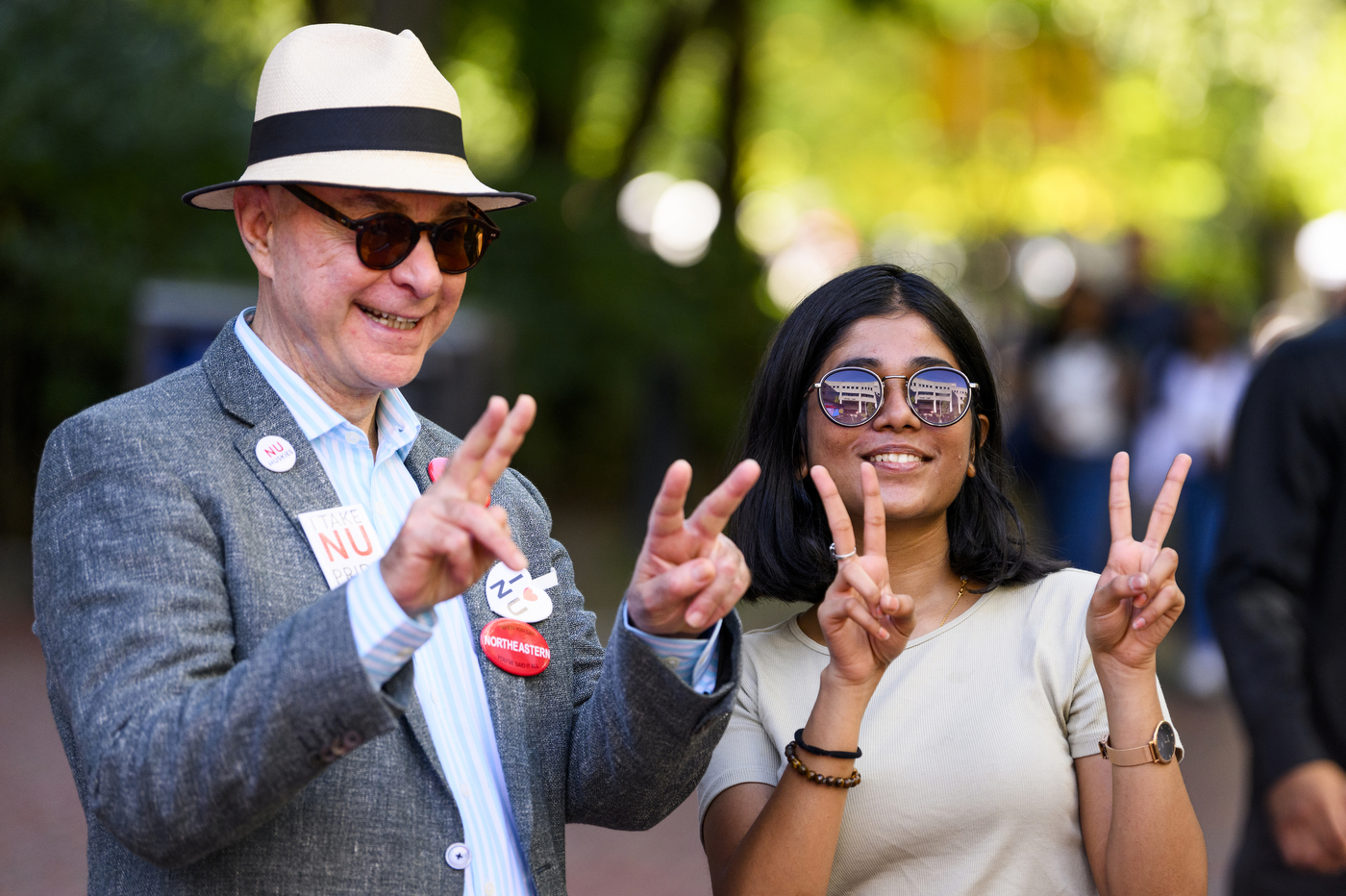 President Aoun posing for a photo with another person, both holding up peace signs.