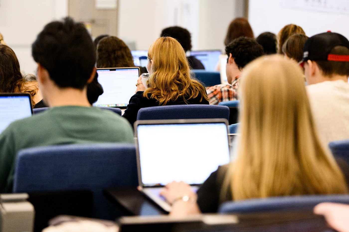 Students on their laptops in class.