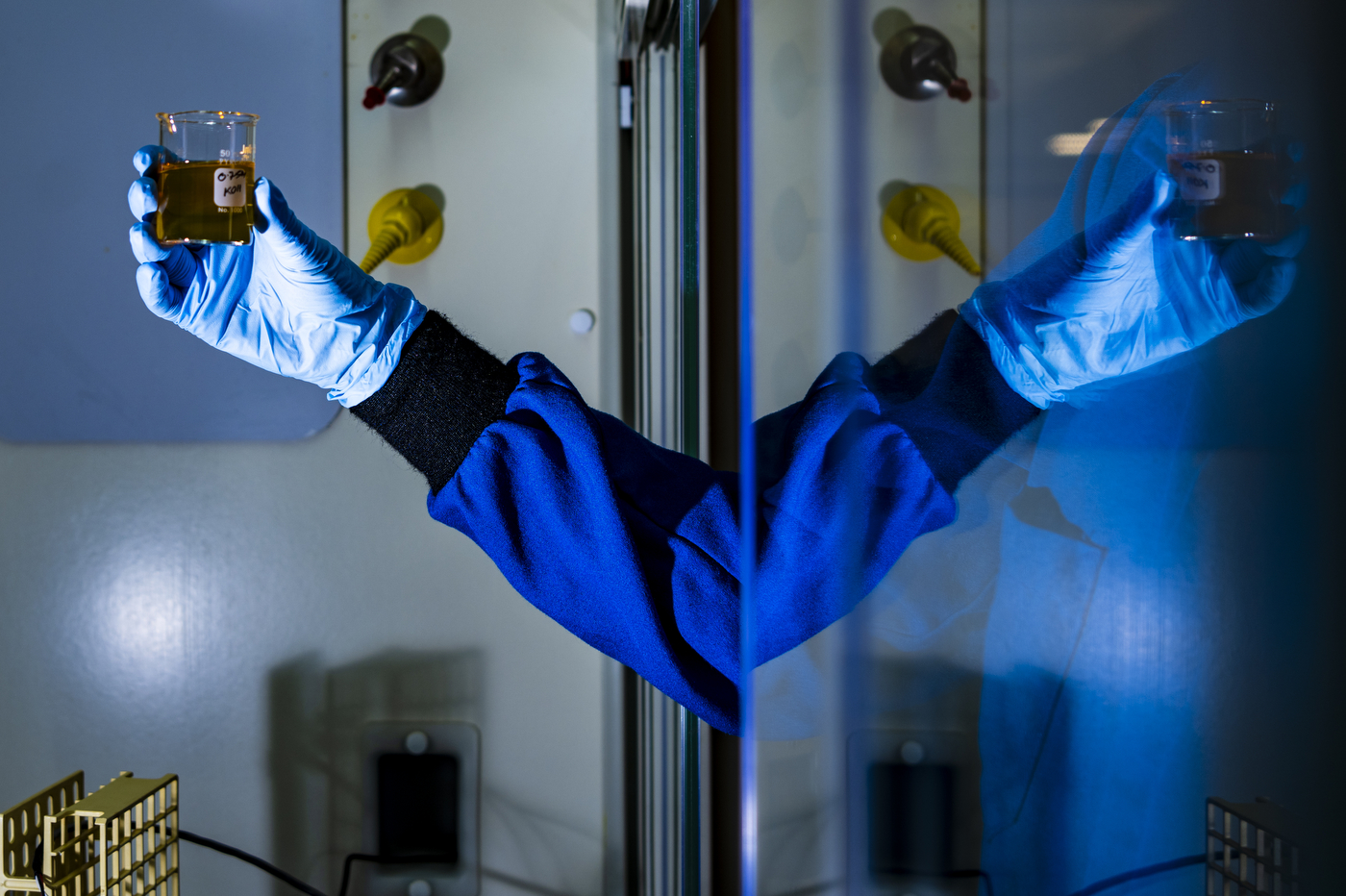 Magda H. Barecka holding up a sample in the lab.