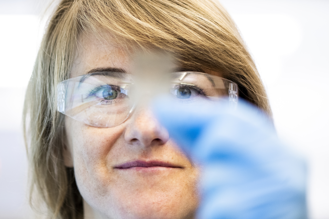 Magda H. Barecka looking at a sample in the lab.