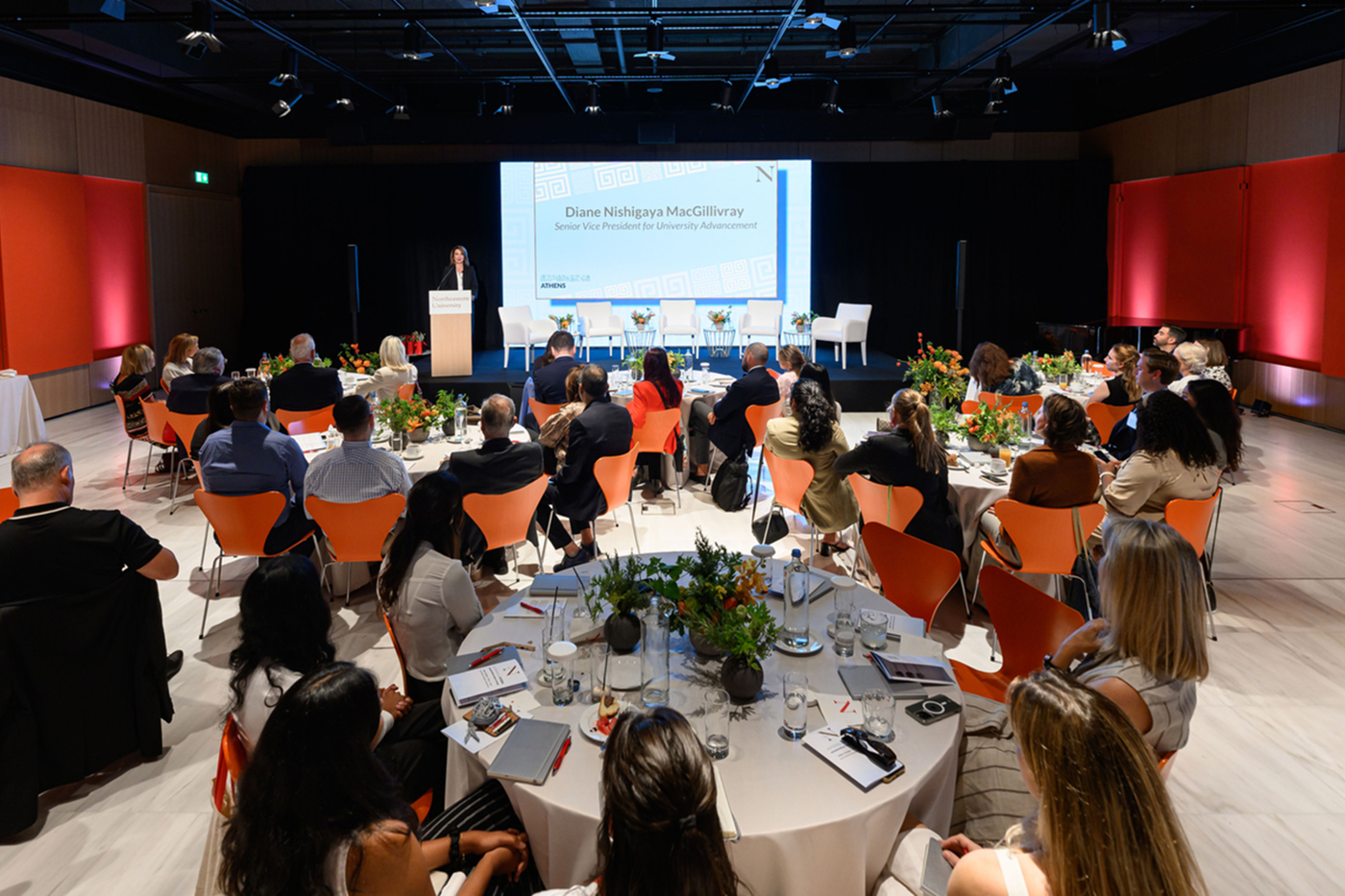 Audience members sitting at round tables at the “Experience Athens: Intergenerational Leaders Exchange" event.