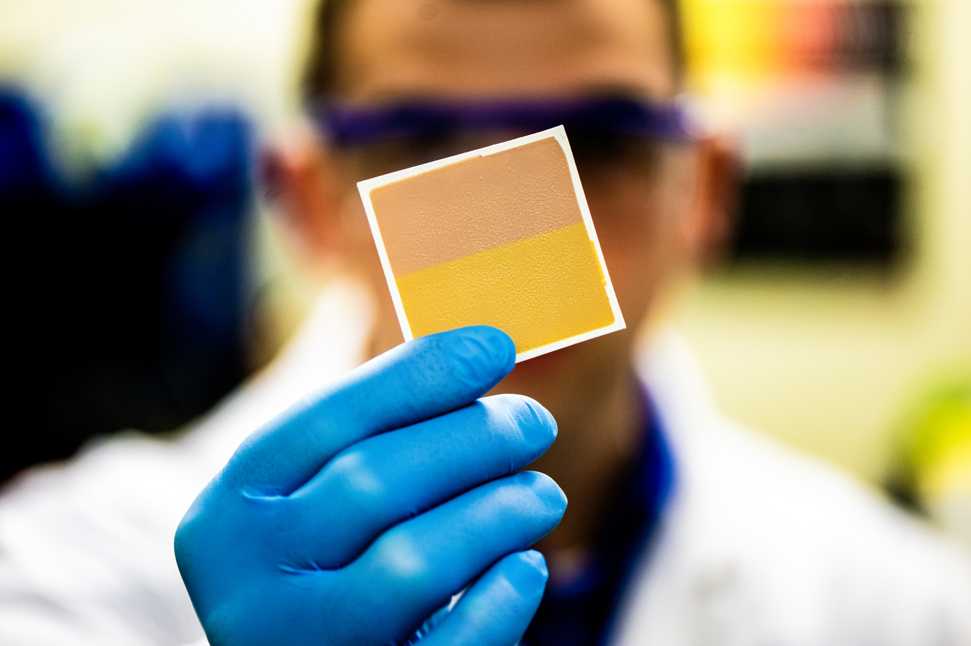 Dan Wilson holding up a sample of color changing paint.