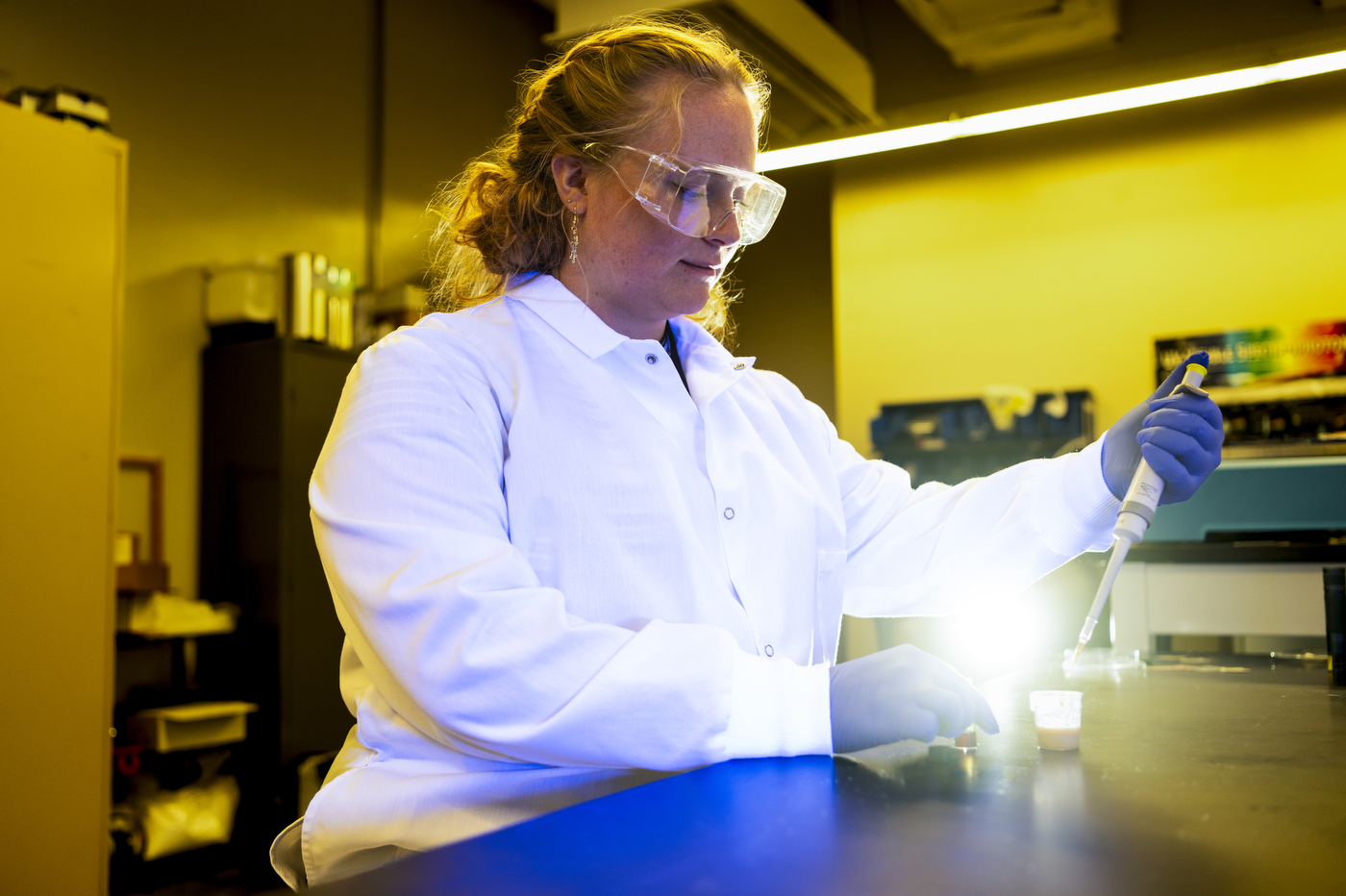 Kaitlyn Flynn mixing colorants in the lab.