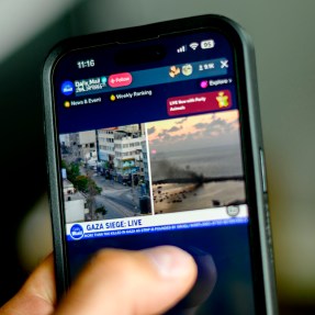 Person using their phone to look at news.