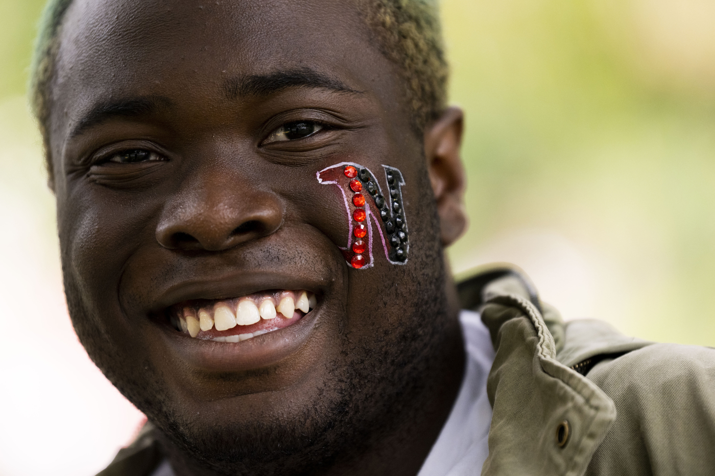 Person with a Northeastern face paint tattoo.