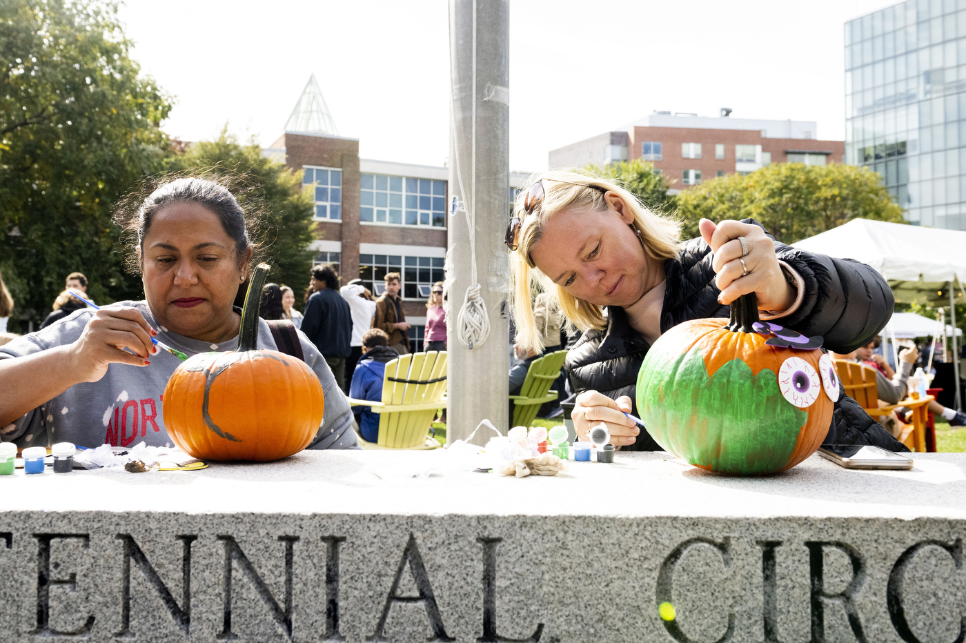 People painting pumpkins at Family and Friends weekend.