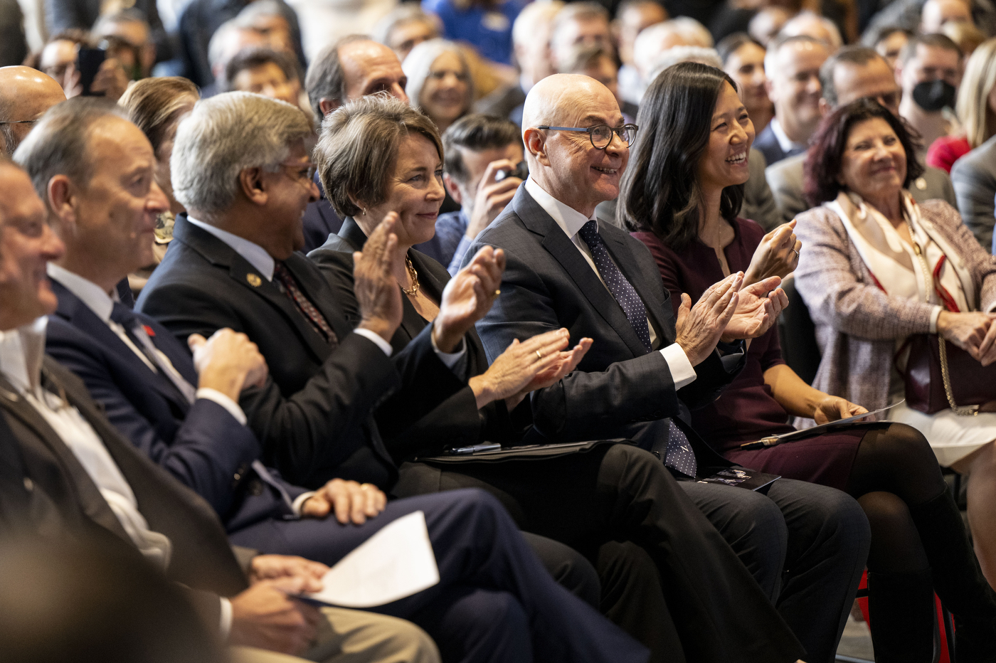 Audience members clapping at the EXP grand opening.