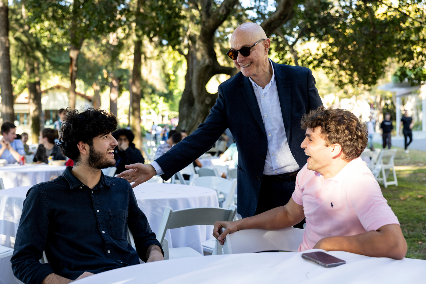 President Aoun talking with two students.