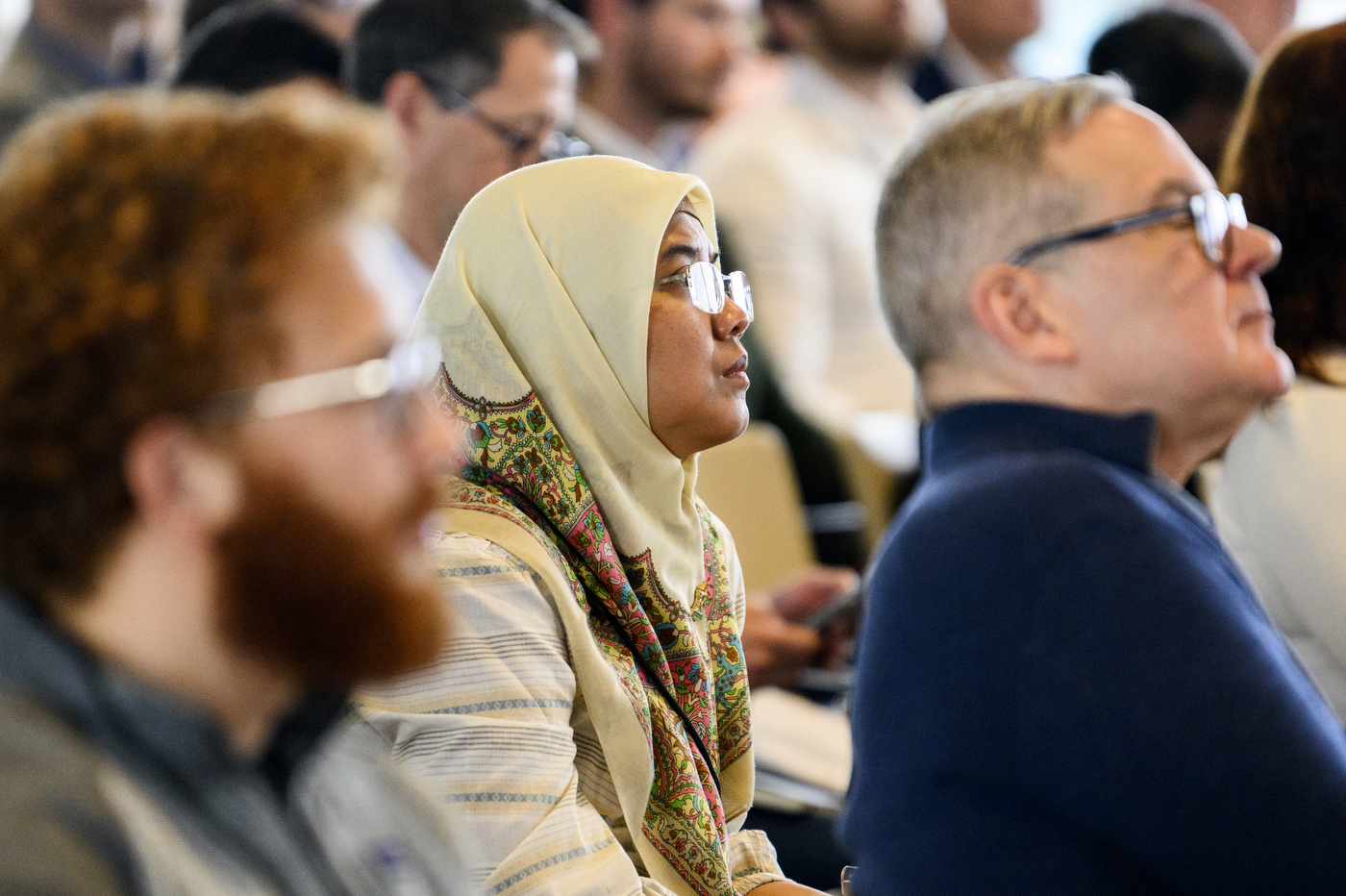 Audience members listening at the AI Business Conference.