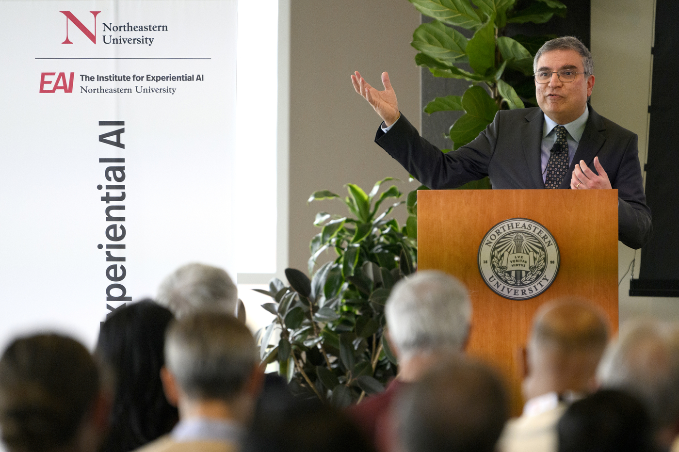 Speaker gesturing at the AI Business Leaders Conference.