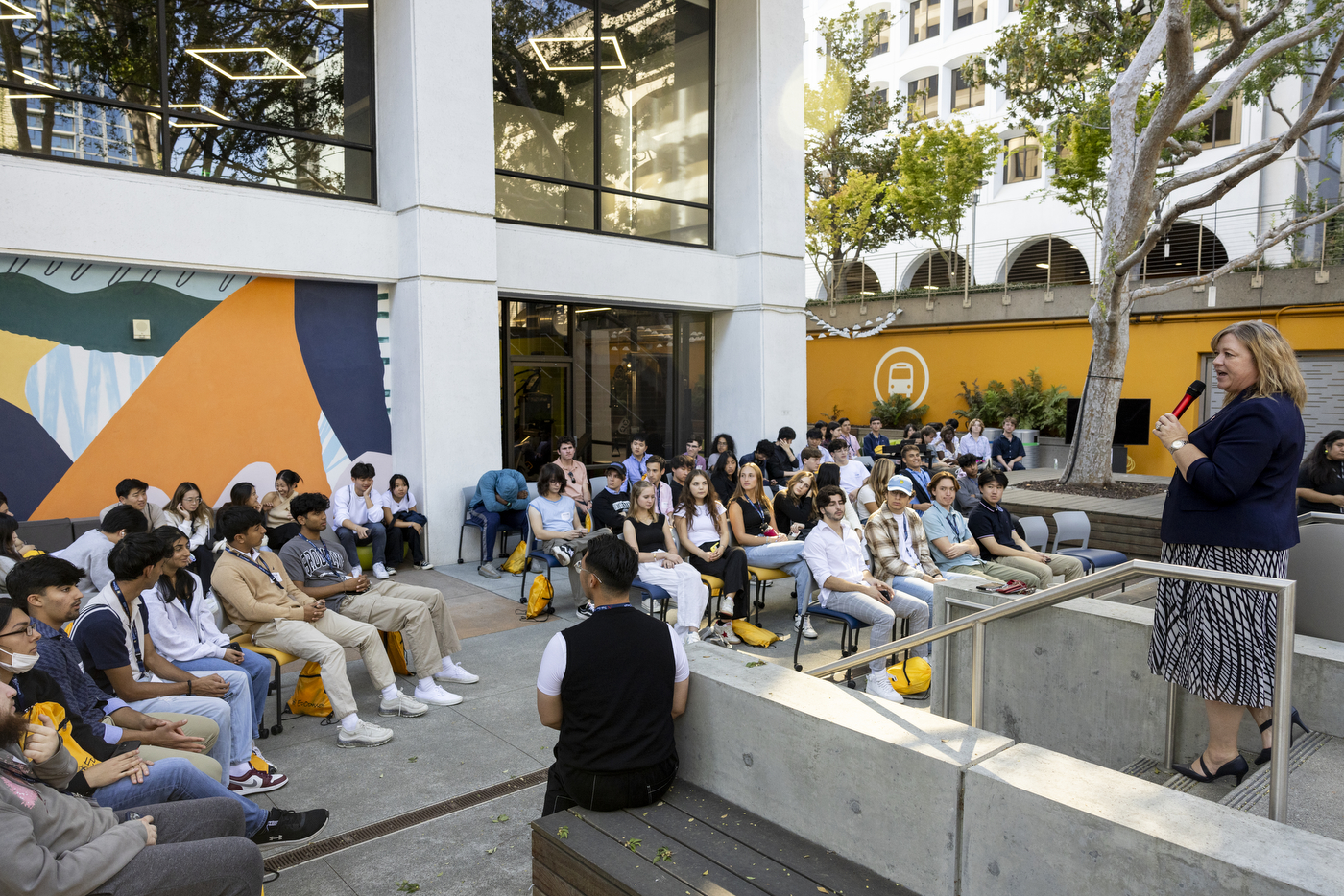 Dawn Girardelli speaks with students outside at Northeastern's Oakland campus.