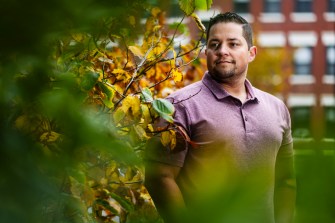 Headshot of Dennis Hernandez standing outside next to a tree.