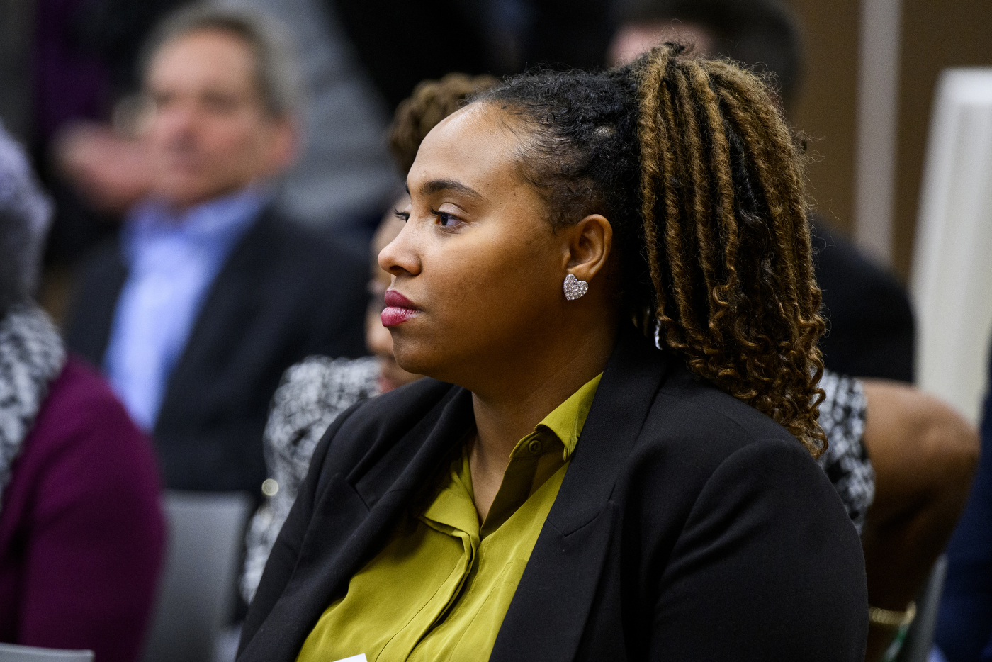 Audience member listening at the event between Roxbury Community College and Northeastern University.