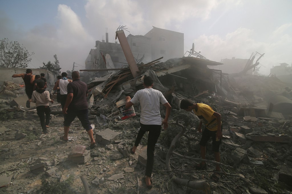 Palestinians looking for survivors among rubble.