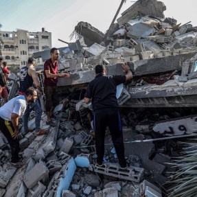 Palestinians searching for survivors among rubble.