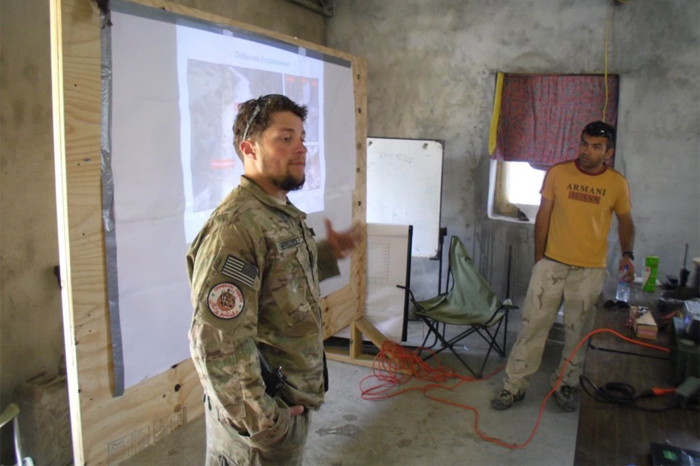 Dennis Hernandez standing in a room in uniform.