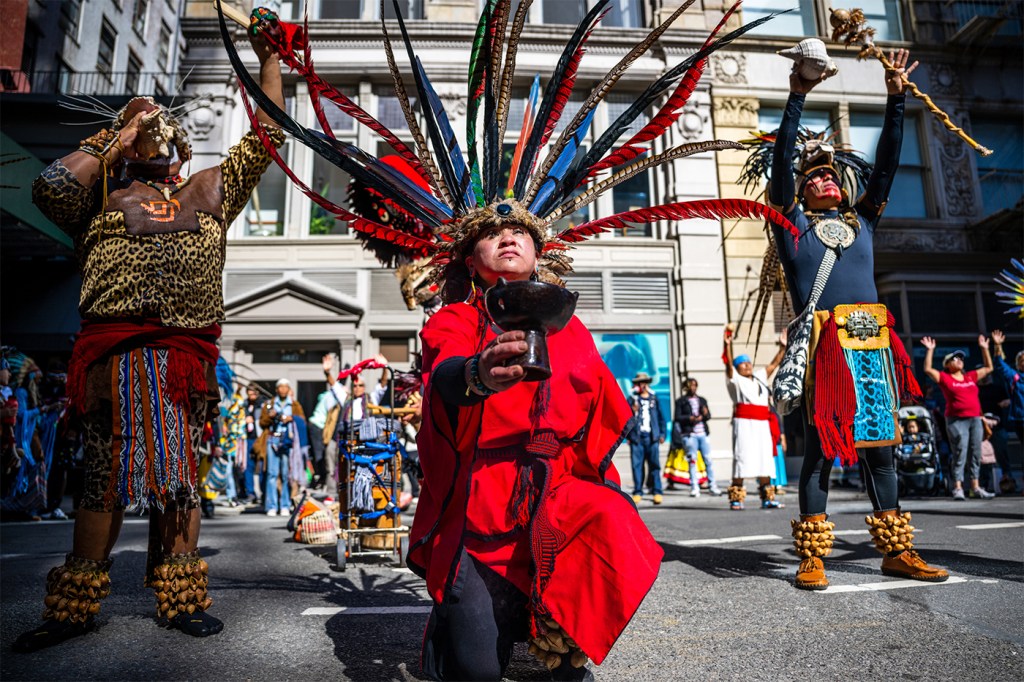 People participating in the Indigenous Peoples of the Americas parade.