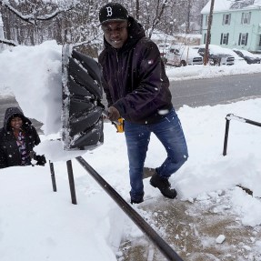 Berry Greg shoveling snow off his front steps.