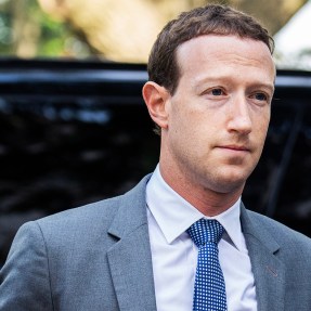 Mark Zuckerberg arriving at Capitol Hill in a grey suit and blue tie.