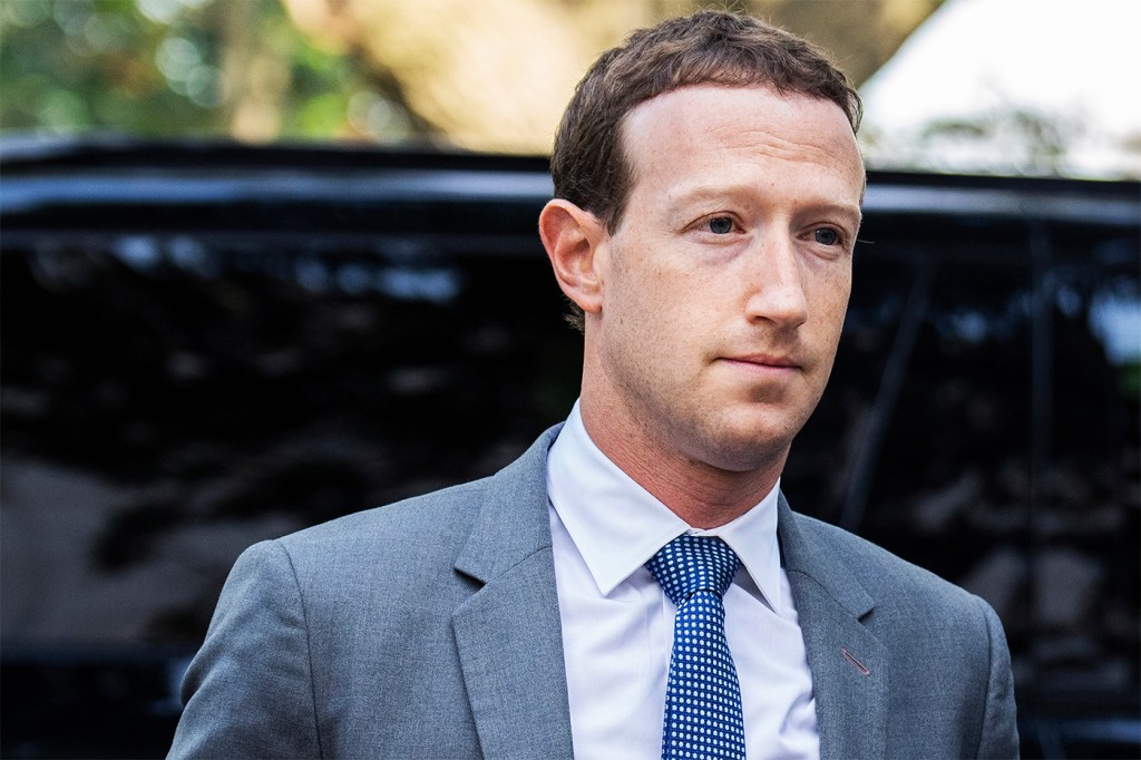 Mark Zuckerberg arriving at Capitol Hill in a grey suit and blue tie.