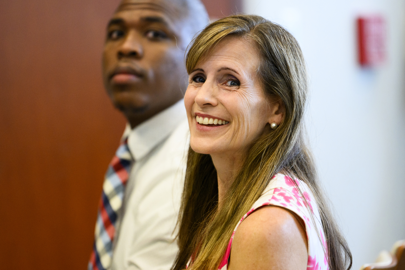 Alicia Modestino and Rashad Cope sitting next to each other at the Bridge to Calculus End of Summer Celebration.