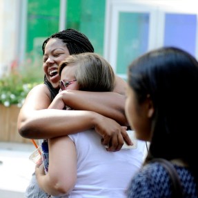 Two people hugging each other.