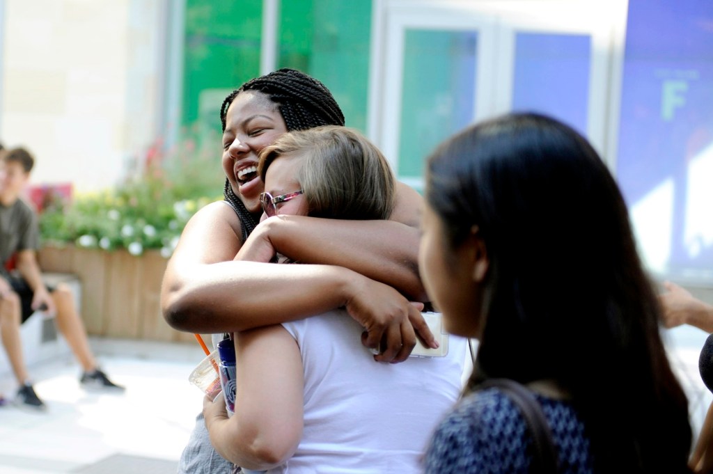 Two people hugging each other.