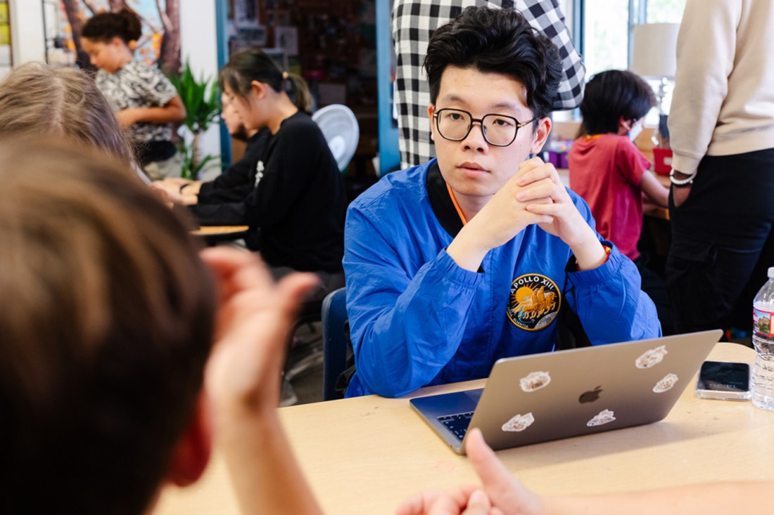 A student listening to another student talk.