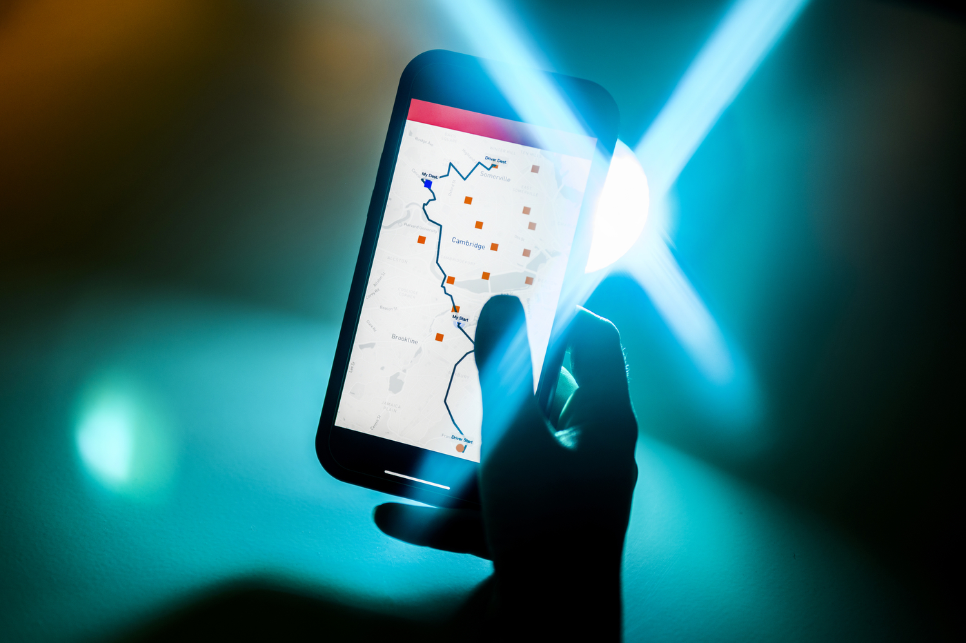 A hand holds a brightly lit phone. 