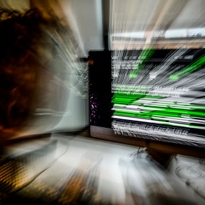 Long exposure photo of a person looking at an AI chatbot on their screen.