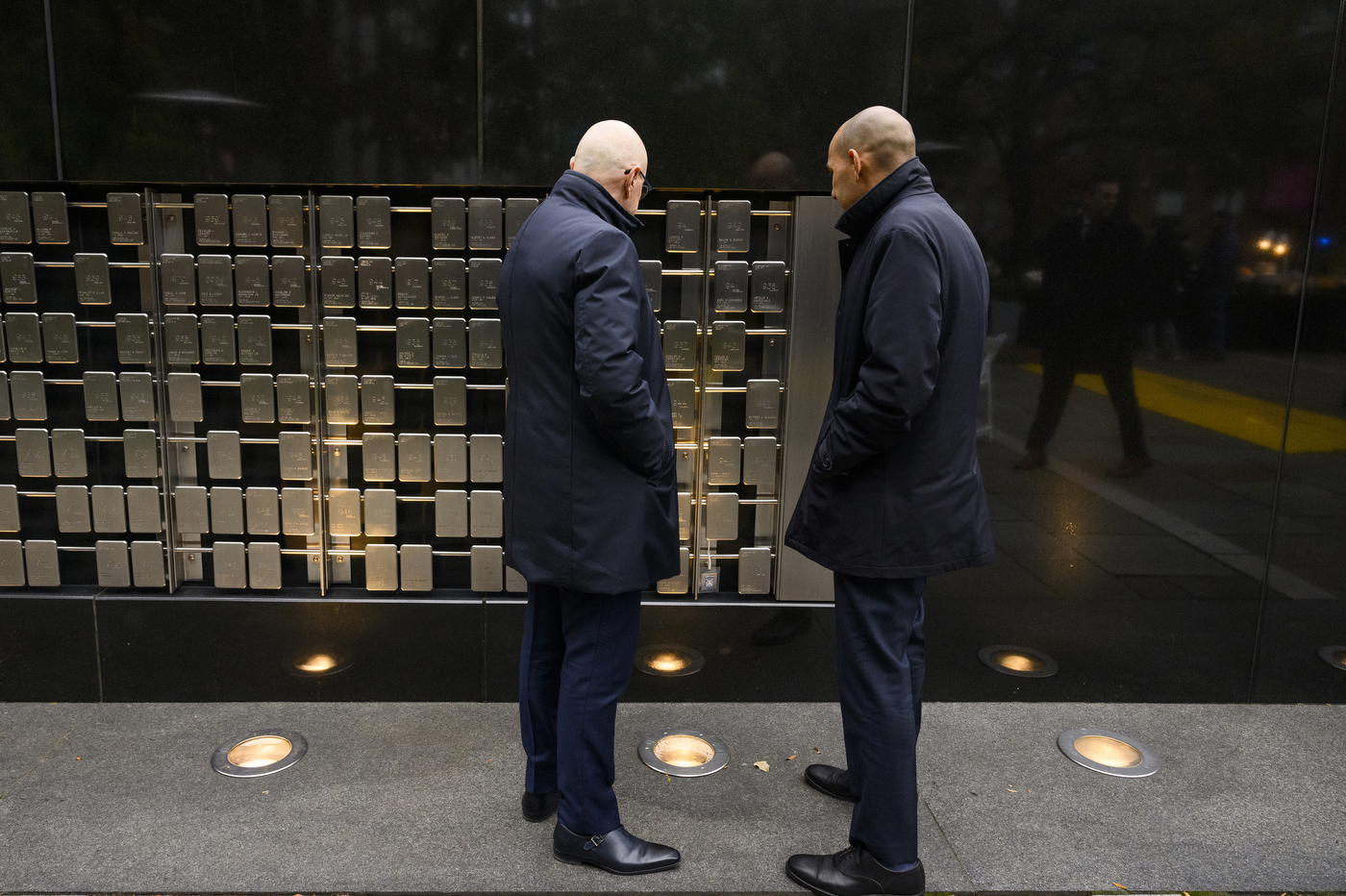 President Joseph E Aoun looking at the veteran plaques on the Boston campus.