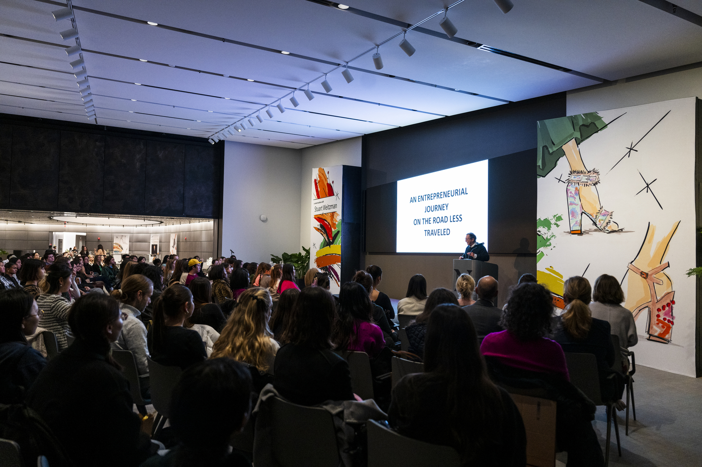 Stuart Weitzman standing in front of an audience at Northeastern University.