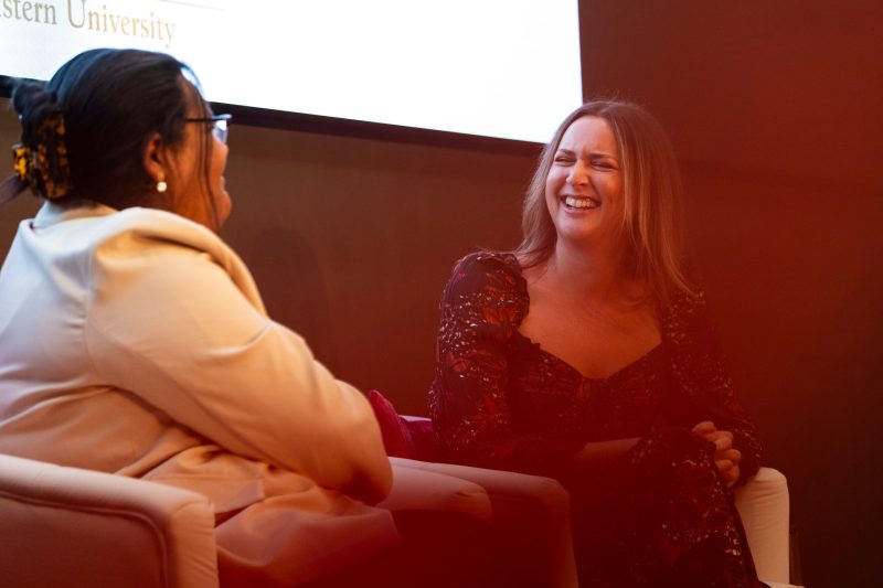 Marissa Mullen laughing with Amelia Brooks while discussing starting a global business. 