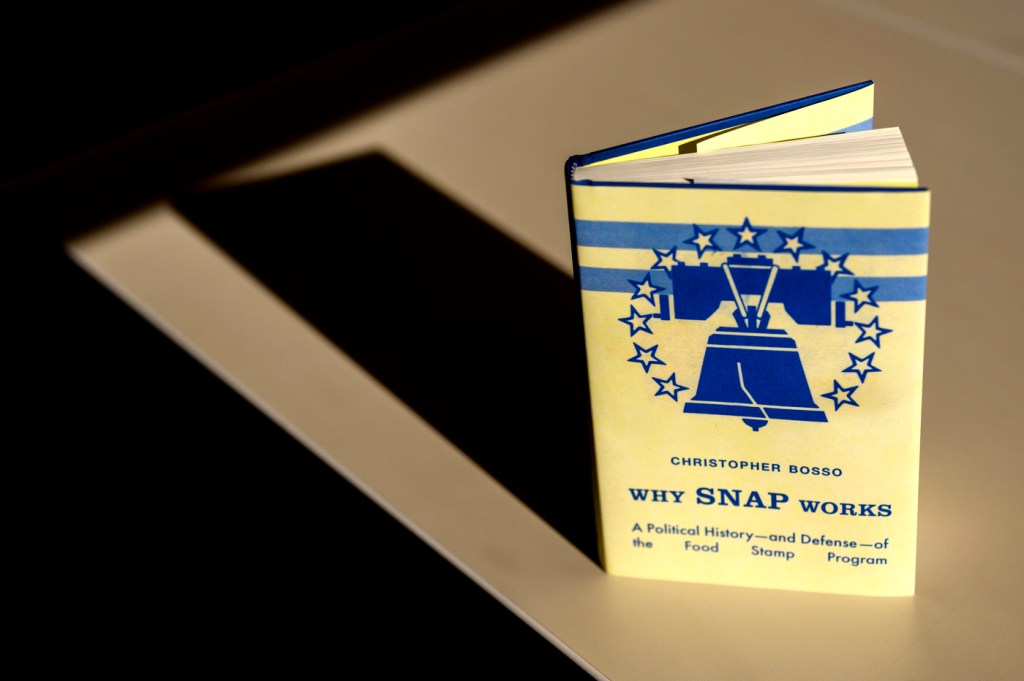 Cover of Chris Bosso's new book, which is yellow with a blue bell on it and titled "Why SNAP Works".