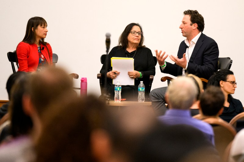 Three people conversing at the Crisis Conversation Series. 