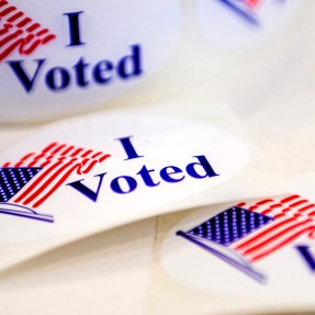 Circular stickers that have US Flags on them and say "I Voted"