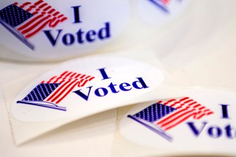 Circular stickers that have US Flags on them and say "I Voted"