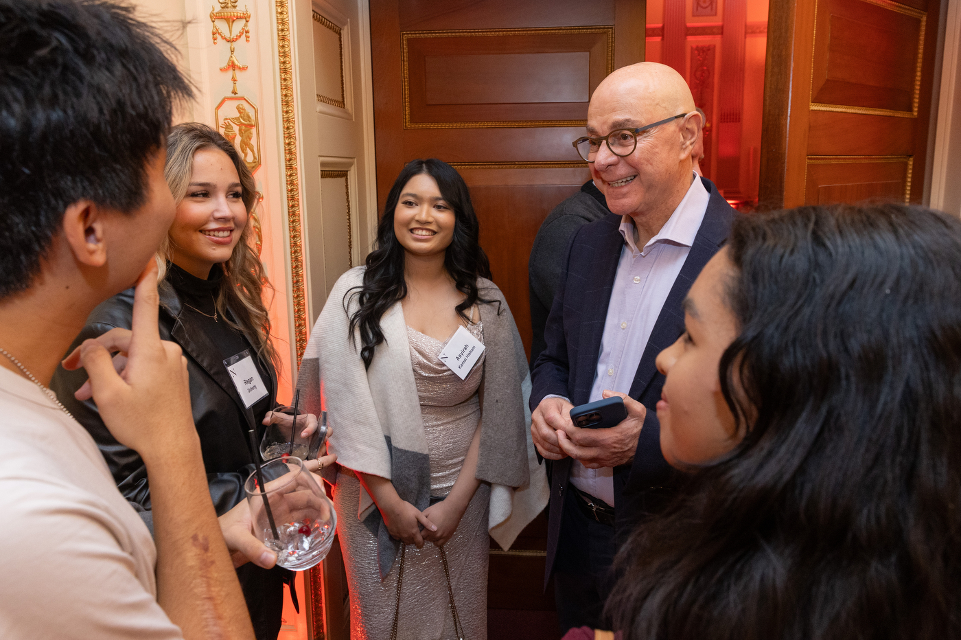 President Aoun talks to four students.