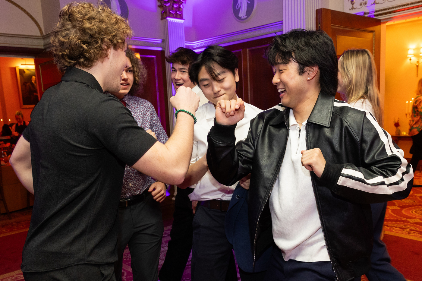 Students dancing together at Northeastern's Thanksgiving celebration.