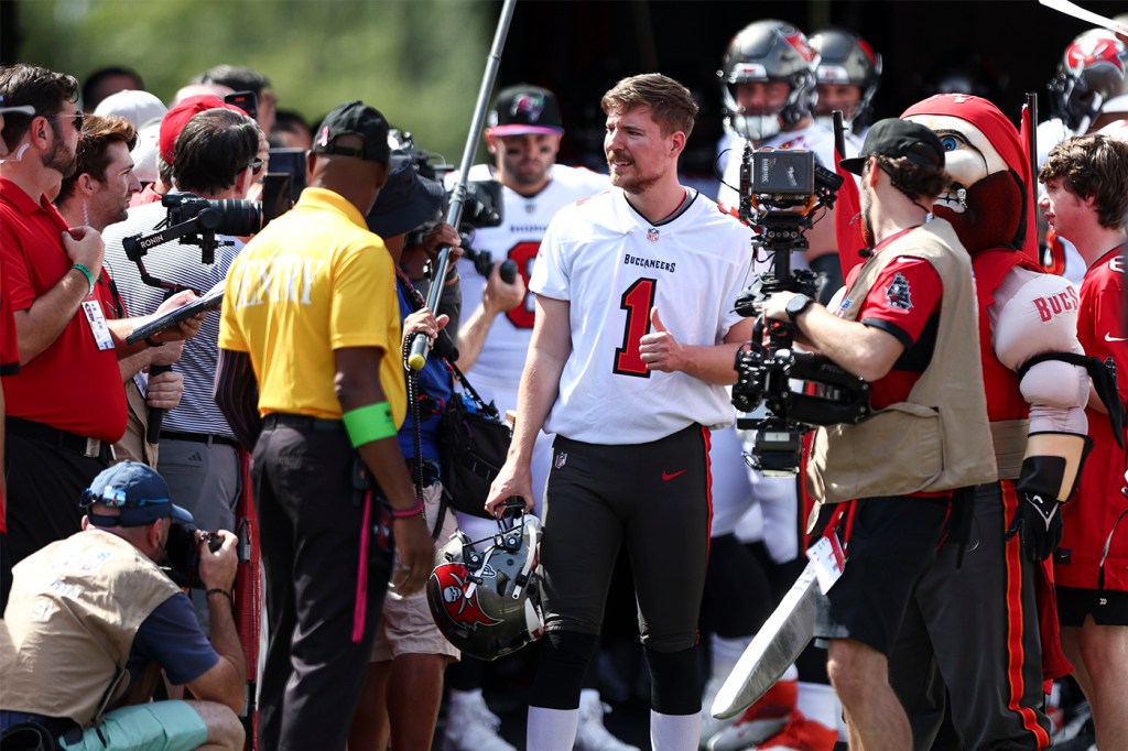 MrBeast wearing a football jersey leading the Tampa Bay Buccaneers out of the tunnel.