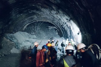 Rescuers inside a collapsed road tunnel.