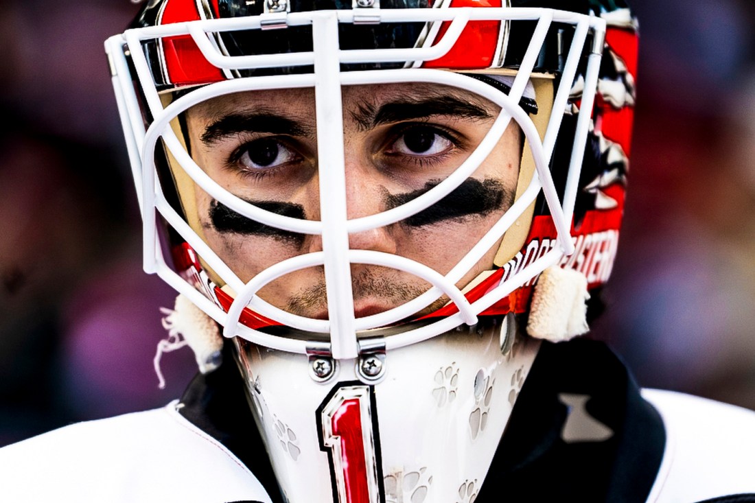Northeastern mens hockey goalie wearing a helmet. 