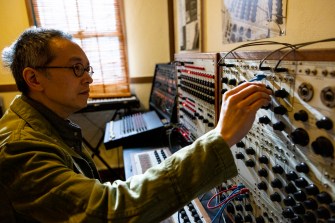 Person using a Don Buchla synthesizer.